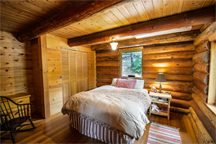 A bedroom in a log home