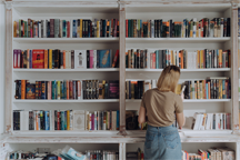 Browsing books in a library. So many books, we must make choices